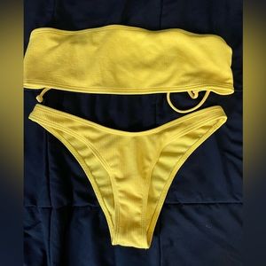 Bathing suit yellow nice never worn tags are off.